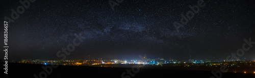 Panoramic view of the starry night sky above the city.