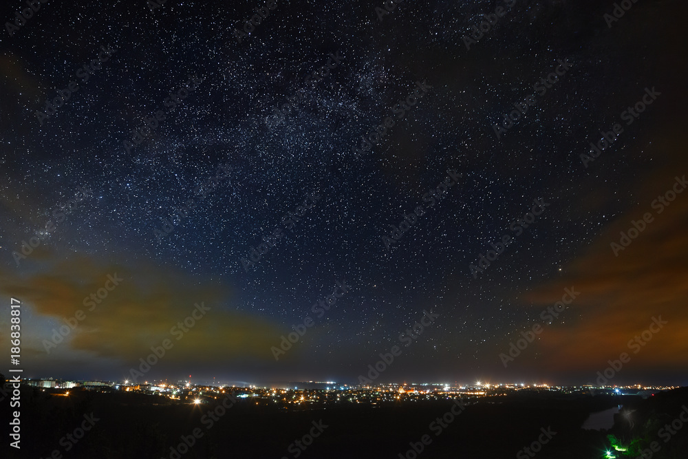 The Milky Way of the starry night sky above the city.