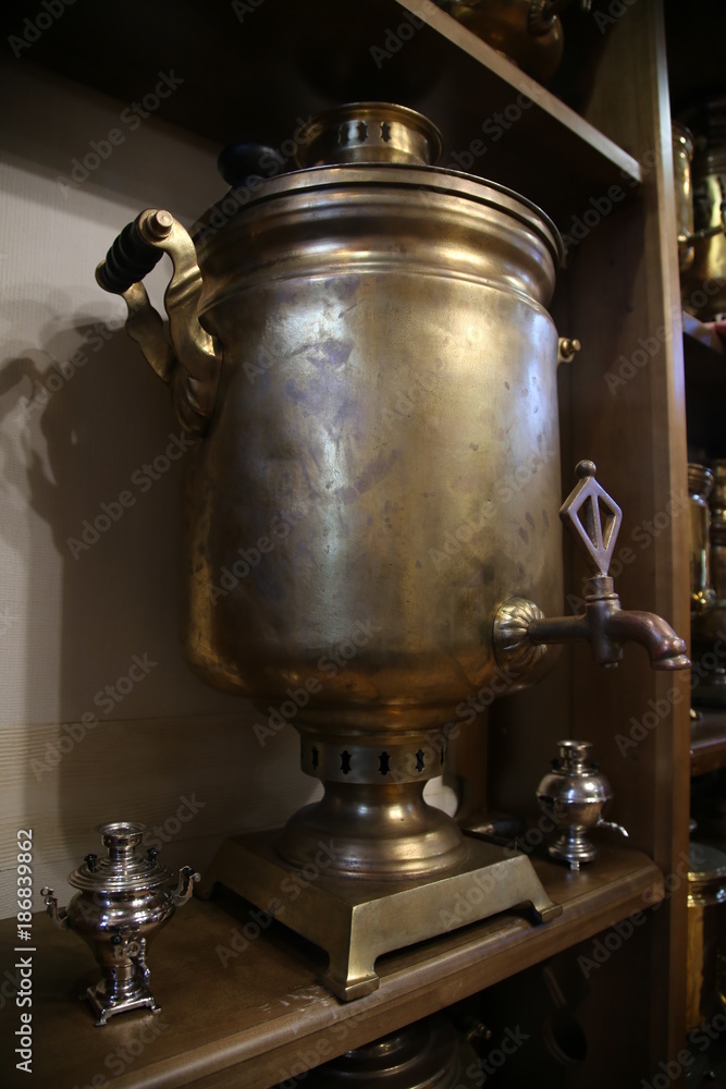 micro samovar and big on the wooden shelf of the cabinet micro samovar and big on the wooden shelf of the cabinet