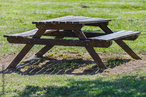 wooden table with benches in the park close-up