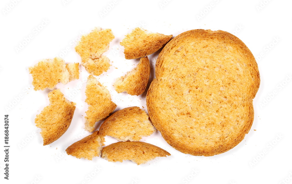 Integral crumbled rusks with wholewheat flour, bread slices isolated on white background, top view