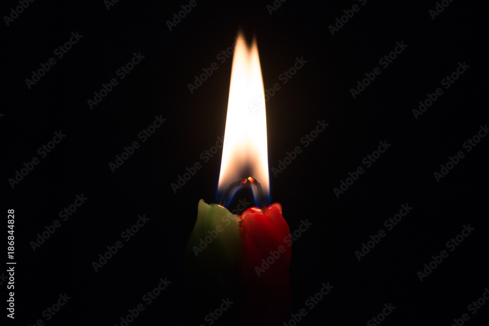 Two burning candles on a black background Two burning candles on a black background