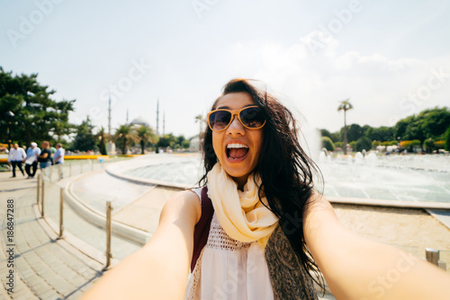 Photography A cheerful teenage girl with glasses shows a cheerful face, funny faces in the c