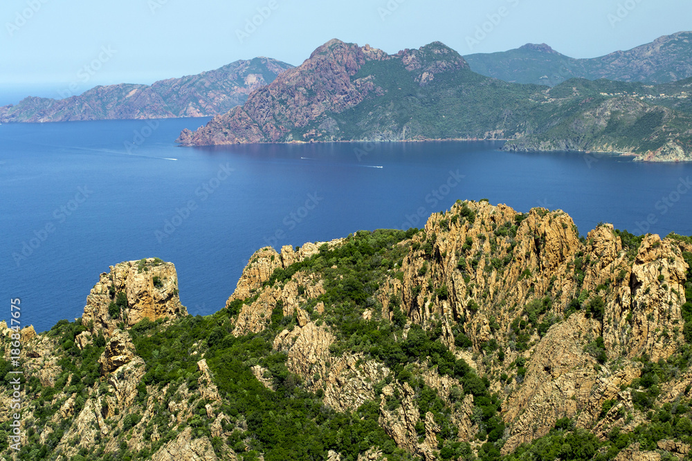 a blue bay among the rocks in the mountains on the island of Corsica