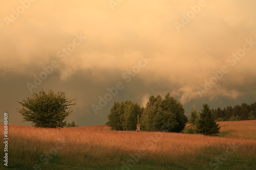 Dramatic sky with big clouds above Pasterka village in Table Mountain in Poland. Stormy weather, natural armagedon.