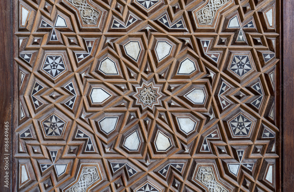 Closeup of arabesque ornaments of an old aged decorated wooden door, Cairo, Egypt