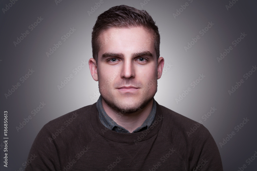 Portrait of handsome attractive young man looking at camera