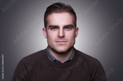 Portrait of handsome attractive young man looking at camera