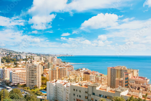 Panoramic aerial top view to Fuengirola town and its surroundings, hotels, resorts, buildings and beaches of Mediterranean sea on sunny day, Andalusia, Spain. Winter relax vacation by the sea concept. photo