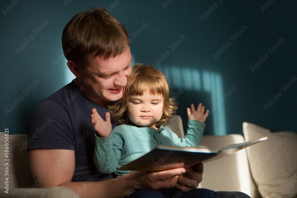 Father reading a story to his child. happy family time together at home.
Father reading a story to his child. happy family time together at home.