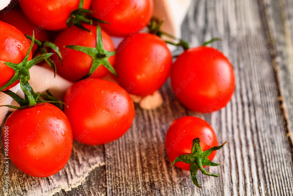 Red ripe tomatoes spill out of sack. Rustic view Red ripe tomatoes spill out of sack. Rustic view