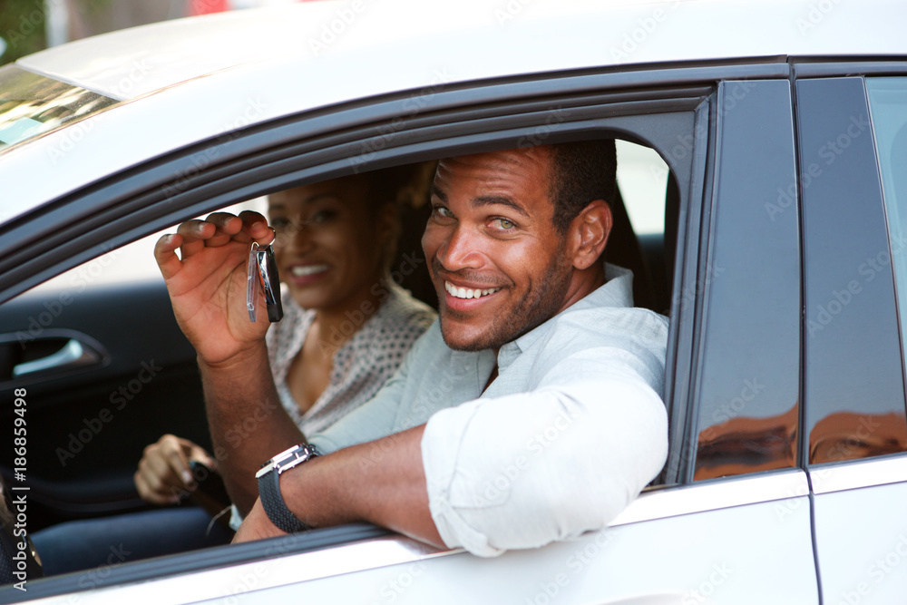 Close up African American couple sitting in car smiling