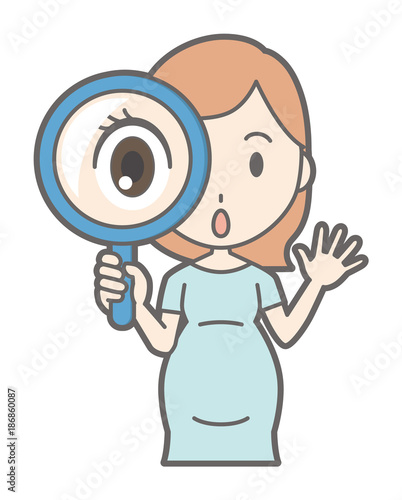 A pregnant woman in green dress has a magnifying glass