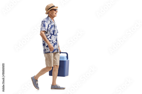 Принти на полотні Elderly tourist with a cooling box walking