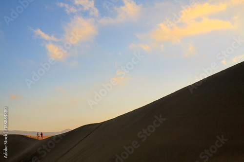 Two tourists walking at sand desert in Maspalomas on Gran Canaria. © cegli