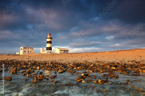 Lighthouse lansdcape with reflections in the water and moody sky, Cape Recife, Port Elizabeth, South Africa