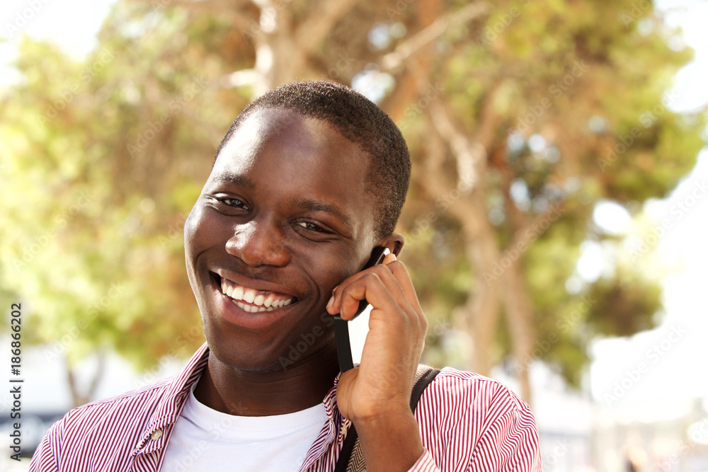 Close up happy college student talking on mobile phone outside Close up happy college student talking on mobile phone outside