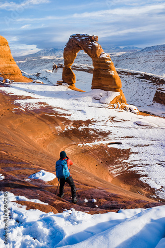 The Photographer taking pictures at Delicate Arch with Snow in Winter