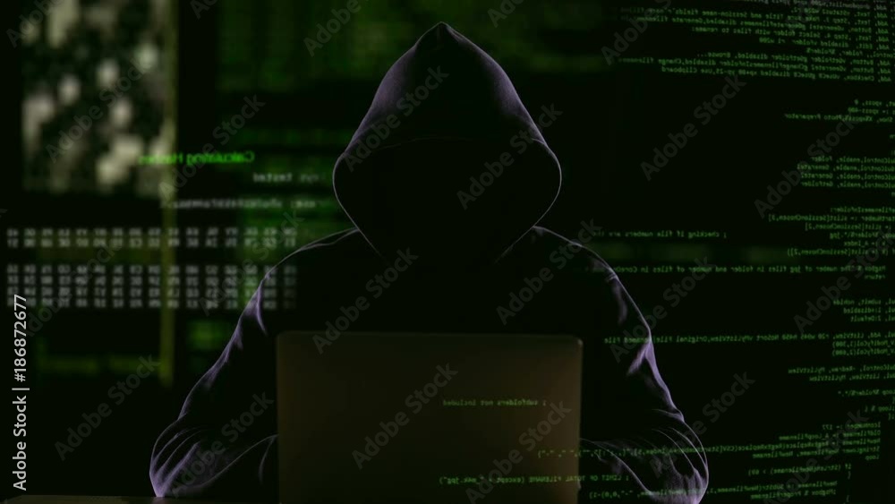 Hacker opening laptop to check virus breaking system codes, stealing data