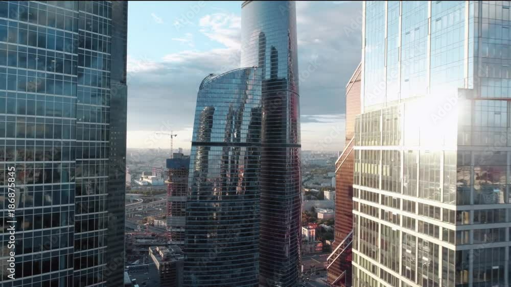 A sun set drone Aerial shot of skyscrapers of business centre, 4K Ultra HD real time video. Urban scene of financial company office. Camera moving slow forward buildings. Moscow skyline