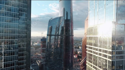 A sun set drone Aerial shot of skyscrapers of  business centre, 4K Ultra HD real time video. Urban scene of financial company office. Camera moving slow forward buildings. Moscow skyline