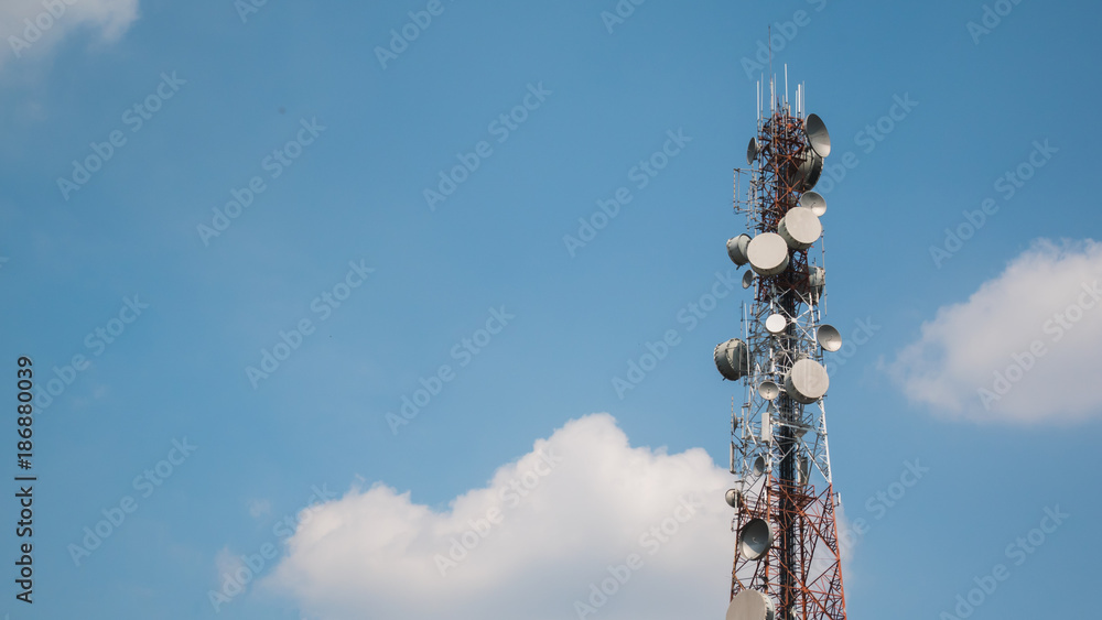 Telecommunications tower against blue sky with space for insert text