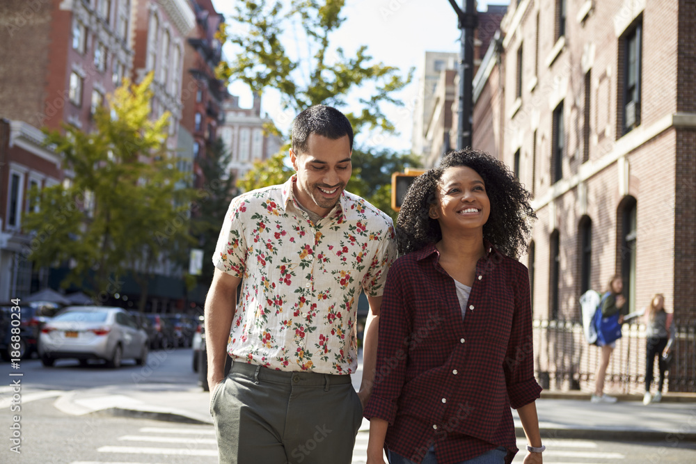 Young Couple Walking Along Urban Street In New York City