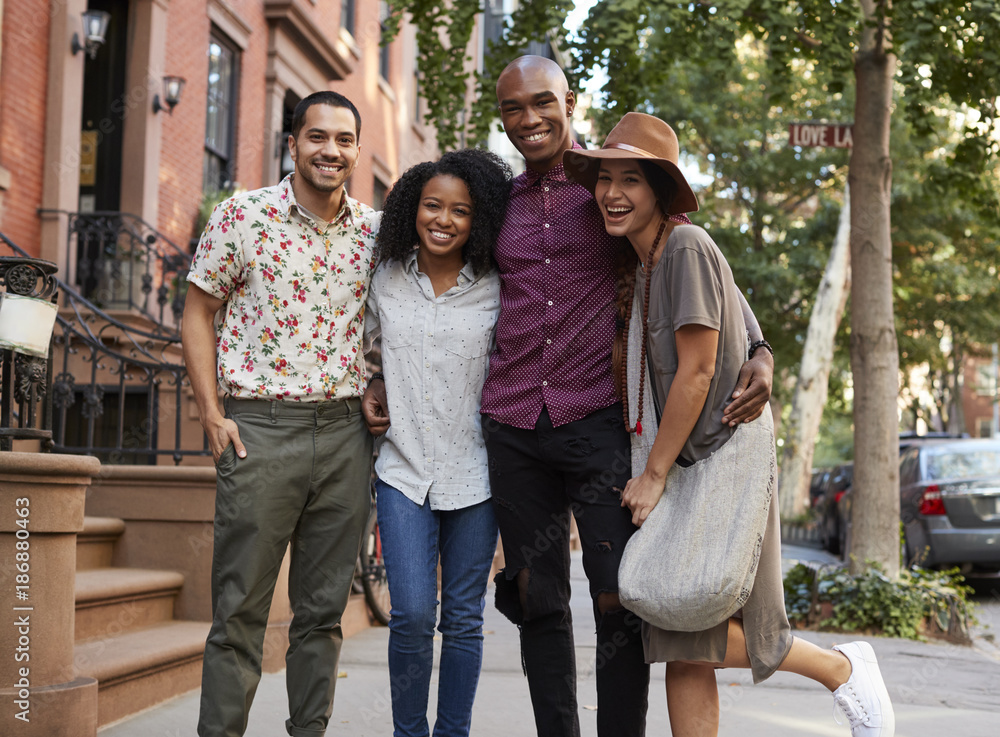 Fototapeta premium Portrait Of Friends Walking Along Urban Street In New York City