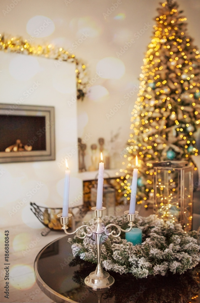 Cozy winter christmas interior with candles, fireplace