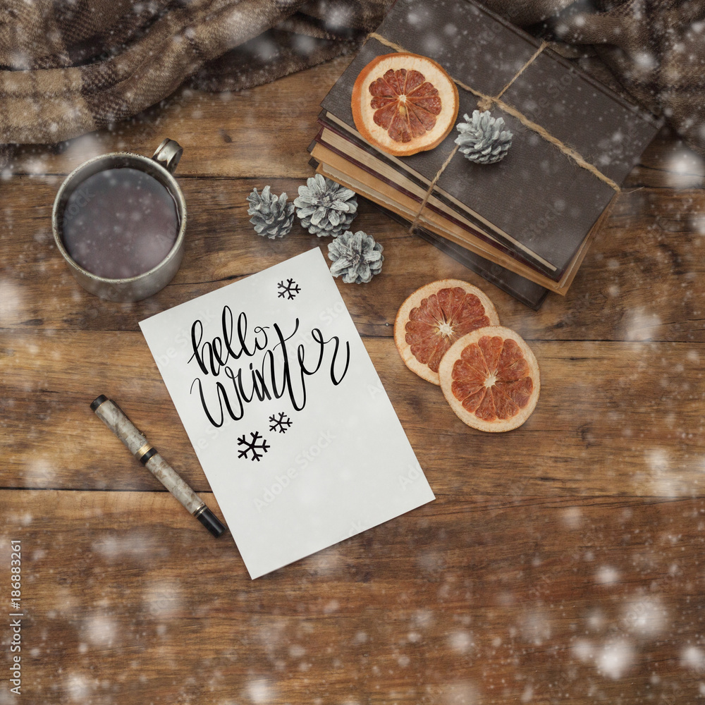 Beautiful composition on a winter theme with a mug of hot tea, a plaid, a diary and a pen Beautiful composition on a winter theme with a mug of hot tea, a plaid, a diary and a pen