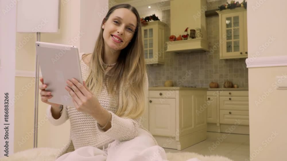Young lady uses tablet at home Young lady uses tablet at home