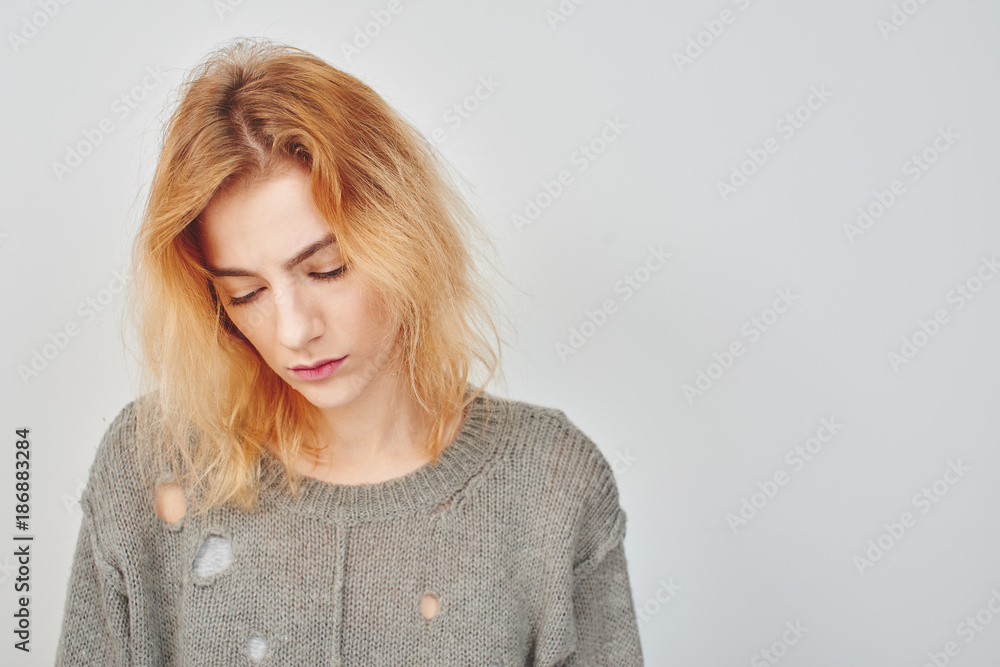 Mental disorder. Sad girl in a depression on a white background.