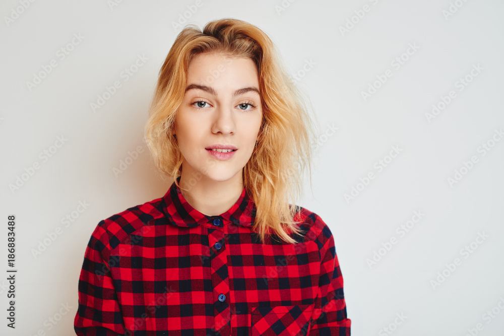 Portrait of young beautiful blonde. Girl in red shirt on white background. Student. Portrait of young beautiful blonde. Girl in red shirt on white background. Student.