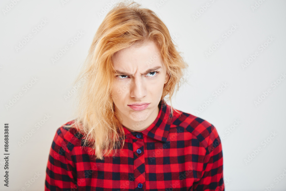 Portrait of a young girl with the expression of the emotion of discontent and resentment Portrait of a young girl with the expression of the emotion of discontent and resentment