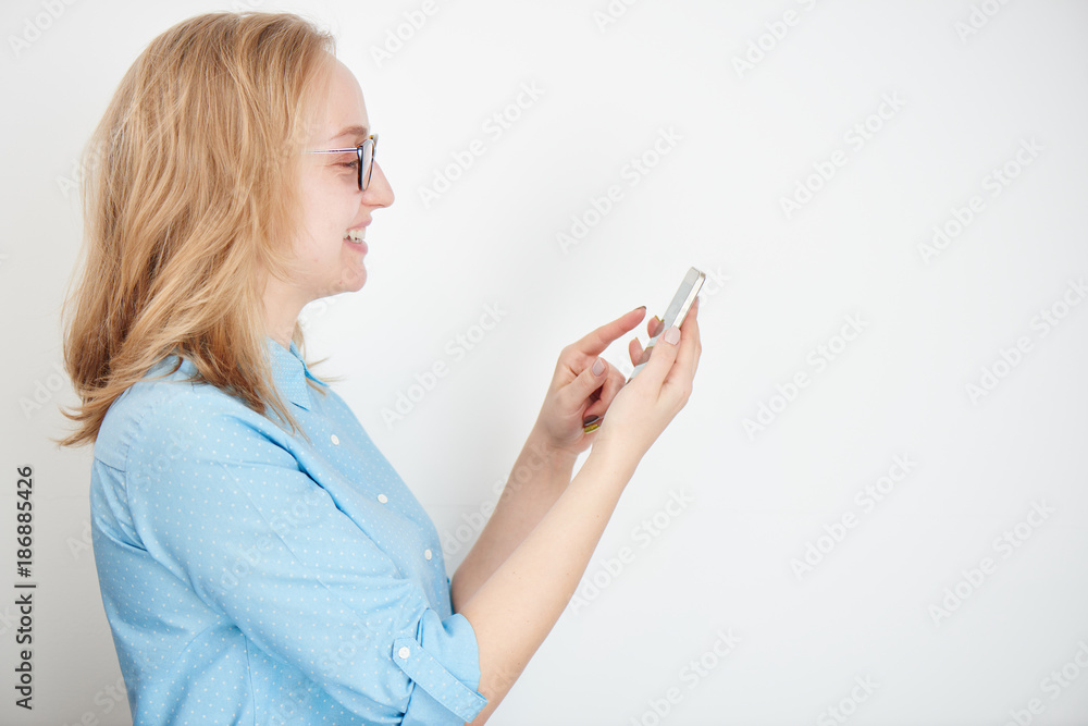 Blonde girl with cellphone on white background Blonde girl with cellphone on white background