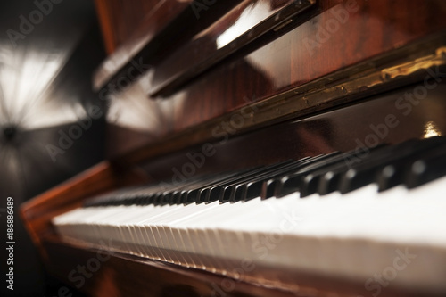 Piano keys on wooden brown musical instrument