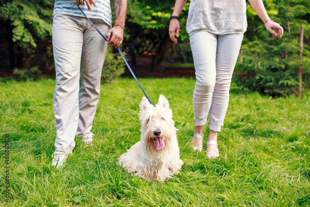White dog with owners White dog with owners
