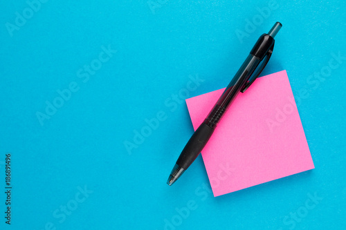 pink post with black pen on blue background