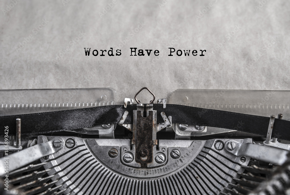 words have power - words, phrase. retro vintage aged typewriter with white blank sheet of paper