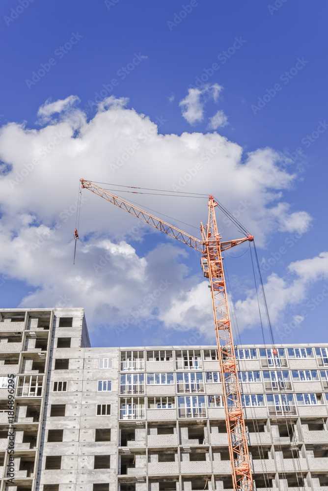 housing construction. crane. new home. blue sky