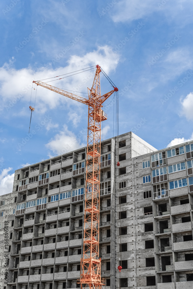 Building. Crane towering over the concrete structure. Building. Crane towering over the concrete structure.