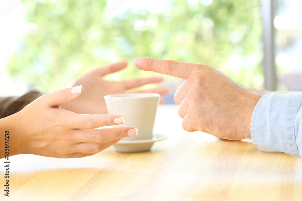 Friends hands arguing in a restaurant or home Friends hands arguing in a restaurant or home
