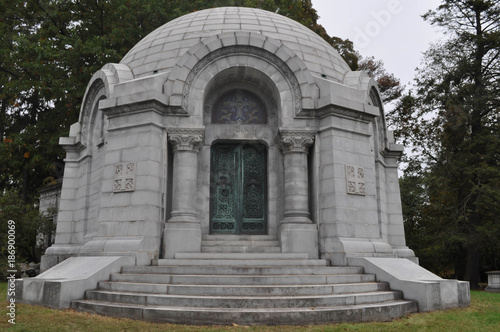 Round Mausoleum with Decorative Iron Doors in a Cemetery