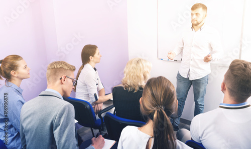 Male teacher giving presentation for students