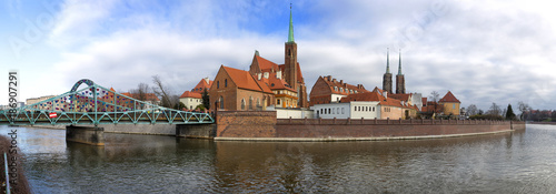 Panoramic view of Ostrow Tumski district in Wroclaw city with Collegiate Church of the Holy Cross and St Bartholomew  Cathedral of St John the Baptist  Archbishop s  palace from Oder River.