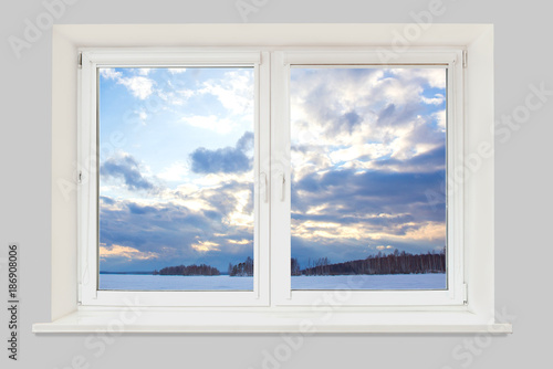 View from the window to the winter landscape with a frozen lake