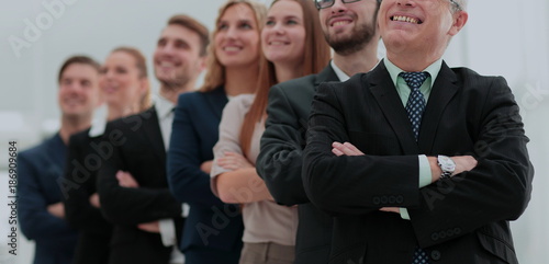 Close-up of employees of a business team standing with crossed a