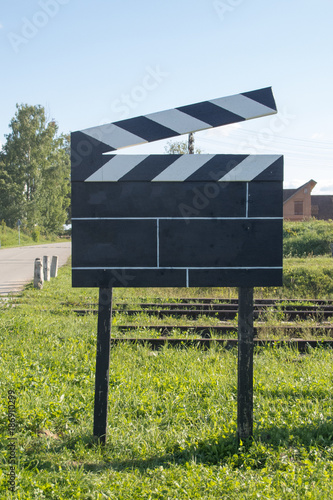 Cinema Concept Big Size Movie Clapper at Ourside on Green Grasses at Outside photo