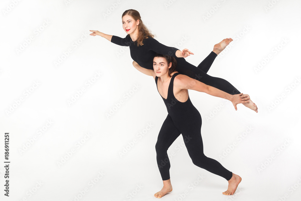 Acrobatic concept, fly pose. Young man holding woman and balancing. Acrobatic concept, fly pose. Young man holding woman and balancing.