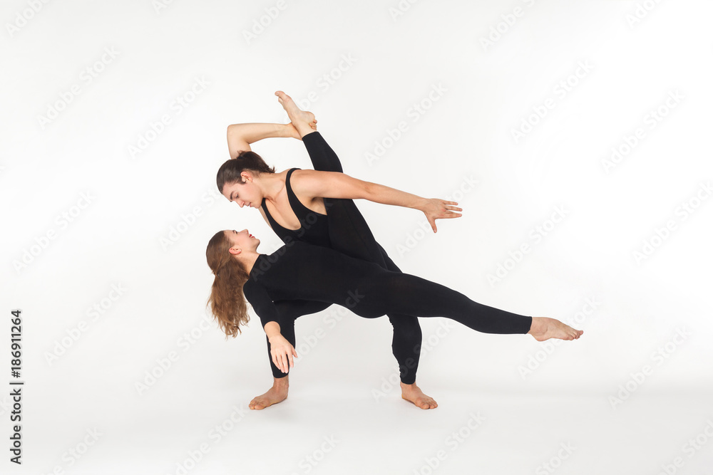 Two flexibility friends dancing, doing performance.
